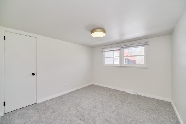 923 Maple St, Ludington, MI 49431 - empty room featuring carpet floors and baseboards