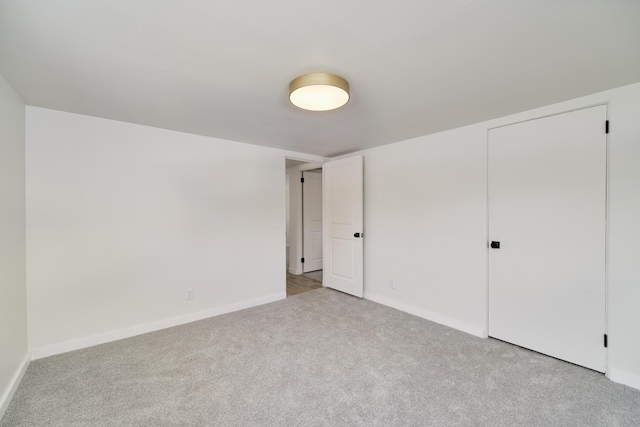 923 Maple St, Ludington, MI 49431 - unfurnished bedroom featuring light colored carpet and baseboards