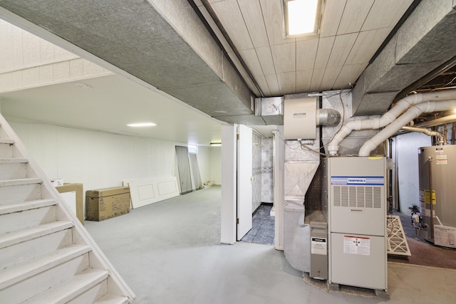 923 Maple St, Ludington, MI 49431 - unfinished basement with gas water heater, heating unit, and stairway