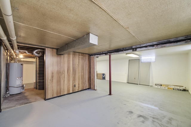923 Maple St, Ludington, MI 49431 - finished basement featuring gas water heater and wooden walls