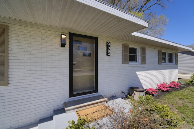 923 Maple St, Ludington, MI 49431 - doorway to property featuring brick siding