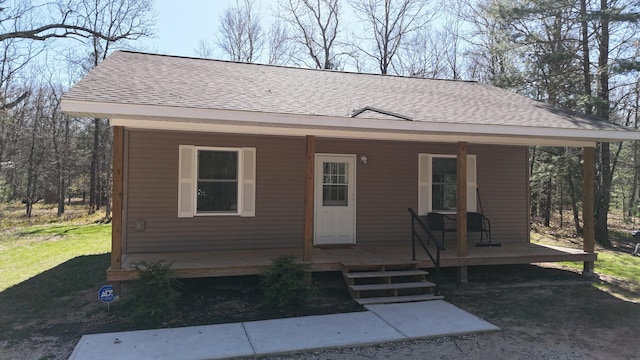 2073 Gunn Rd, Manistee, MI 49660 - bungalow featuring roof with shingles and a porch