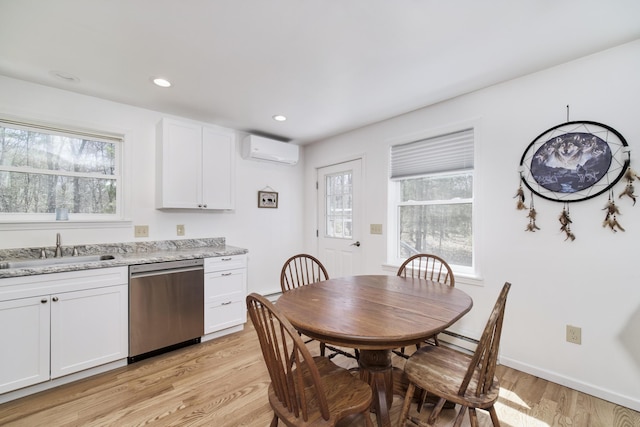 2073 Gunn Rd, Manistee, MI 49660 - dining area with a wall mounted air conditioner, light wood finished floors, recessed lighting, and a baseboard heating unit