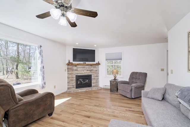 2073 Gunn Rd, Manistee, MI 49660 - living area with plenty of natural light, a baseboard radiator, light wood-style floors, a ceiling fan, and recessed lighting