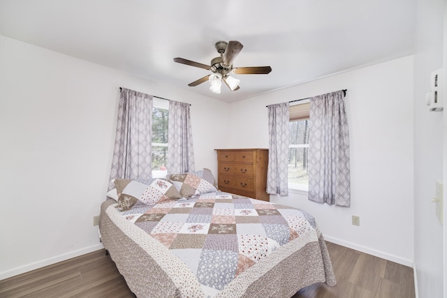 2073 Gunn Rd, Manistee, MI 49660 - bedroom with wood finished floors, baseboards, and ceiling fan