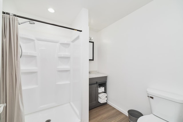 2073 Gunn Rd, Manistee, MI 49660 - full bathroom featuring wood finished floors, a shower stall, baseboards, and toilet