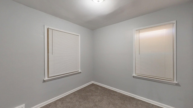 20026 Joann St, Detroit, MI 48205 - spare room featuring dark carpet and baseboards