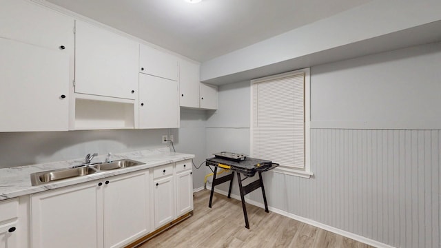 20026 Joann St, Detroit, MI 48205 - kitchen featuring a sink, white cabinetry, light wood-style flooring, and baseboards