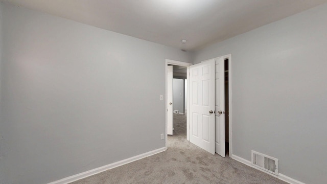 20026 Joann St, Detroit, MI 48205 - unfurnished bedroom featuring light colored carpet, baseboards, and a closet