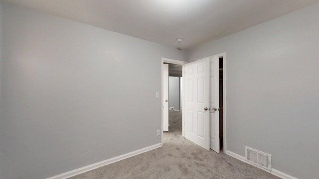 20026 Joann St, Detroit, MI 48205 - unfurnished bedroom with light colored carpet, baseboards, and a closet