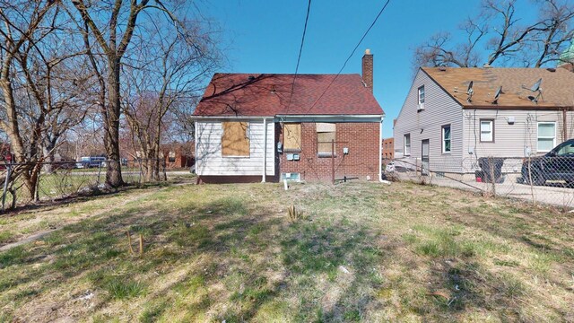 20026 Joann St, Detroit, MI 48205 - rear view of house with a chimney and brick siding