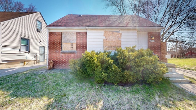 20026 Joann St, Detroit, MI 48205 - view of home's exterior with roof with shingles, brick siding, and a yard