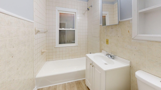 20026 Joann St, Detroit, MI 48205 - full bathroom featuring tile walls, vanity, toilet, wood finished floors, and a tub