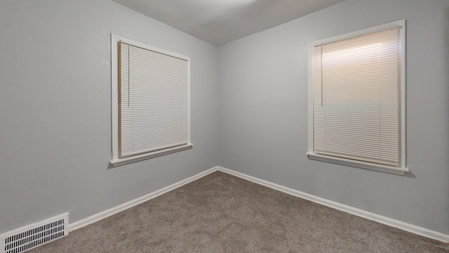 20026 Joann St, Detroit, MI 48205 - empty room with dark colored carpet and baseboards