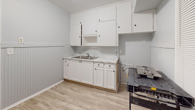 20026 Joann St, Detroit, MI 48205 - kitchen featuring a sink, a wainscoted wall, light wood-style flooring, white cabinetry, and open shelves