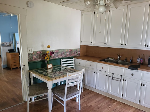 1116 Atlantic St NW, Grand Rapids, MI 49504 - kitchen featuring ceiling fan, a sink, light wood finished floors, and white cabinets
