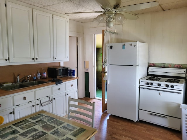 1116 Atlantic St NW, Grand Rapids, MI 49504 - kitchen featuring white appliances, a sink, white cabinets, ceiling fan, and wood finished floors