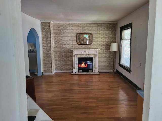 1116 Atlantic St NW, Grand Rapids, MI 49504 - unfurnished living room featuring wood finished floors, a fireplace, and baseboards