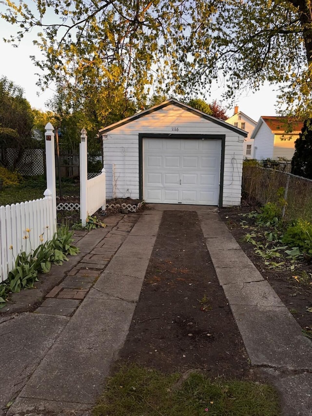 1116 Atlantic St NW, Grand Rapids, MI 49504 - detached garage featuring fence and concrete driveway