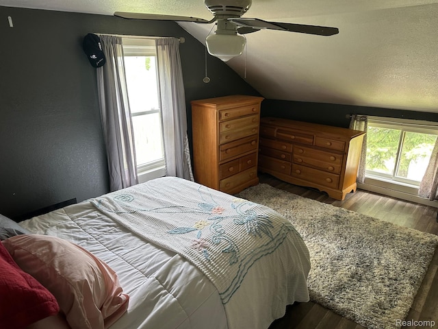 7980 W Gilford Rd, Reese, MI 48757 - bedroom featuring multiple windows, lofted ceiling, wood finished floors, and a ceiling fan