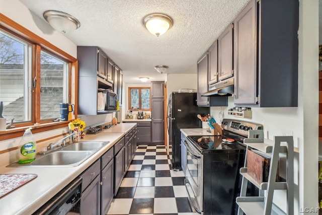 126 Litchfield St, Clinton, MI 49236 - kitchen featuring stainless steel range with electric cooktop, under cabinet range hood, dark flooring, a sink, and a textured ceiling