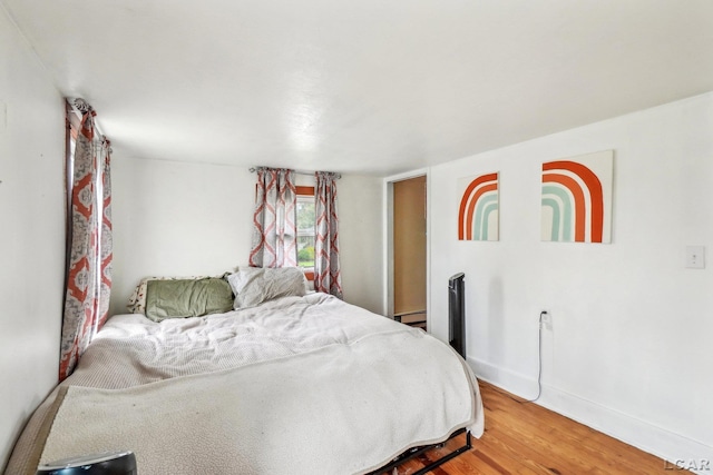 126 Litchfield St, Clinton, MI 49236 - bedroom featuring light wood-type flooring, baseboards, and baseboard heating