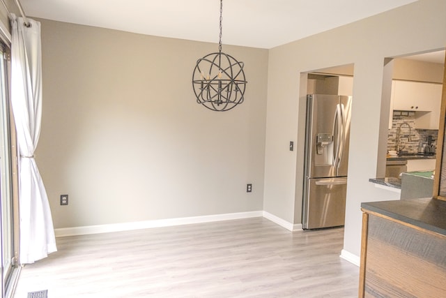 726 Hamilton, Rochester Hills, MI 48307 - unfurnished dining area featuring light wood-type flooring, a chandelier, a sink, and baseboards