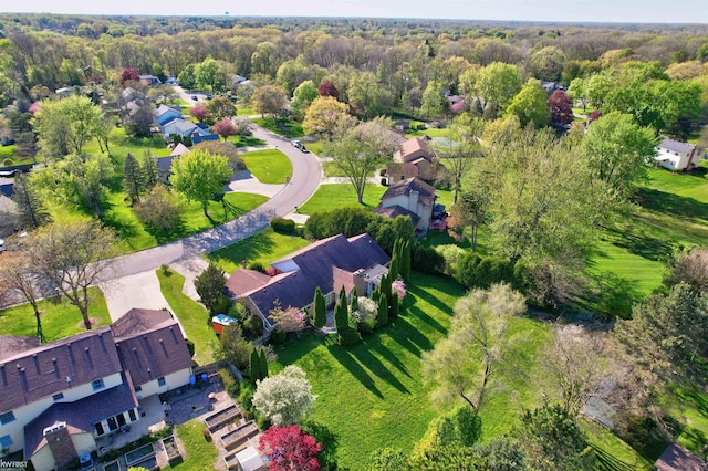 aerial perspective of suburban area featuring a heavily wooded area