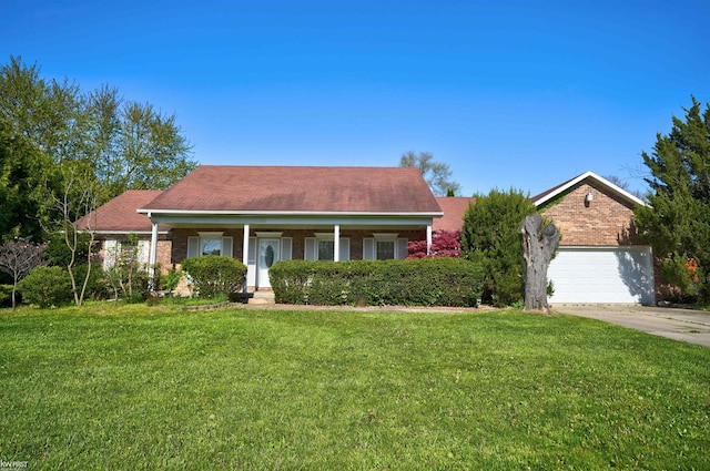 view of front facade featuring brick siding, a front yard, concrete driveway, and a porch