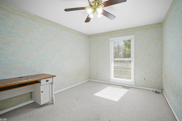 empty room featuring light carpet, baseboards, and a ceiling fan
