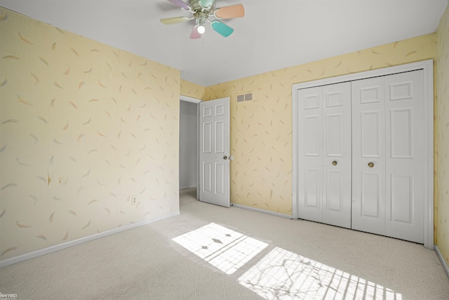 unfurnished bedroom featuring carpet flooring, a closet, ceiling fan, and baseboards