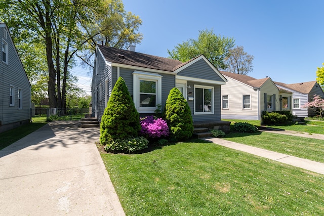 bungalow-style house with a chimney and a front yard