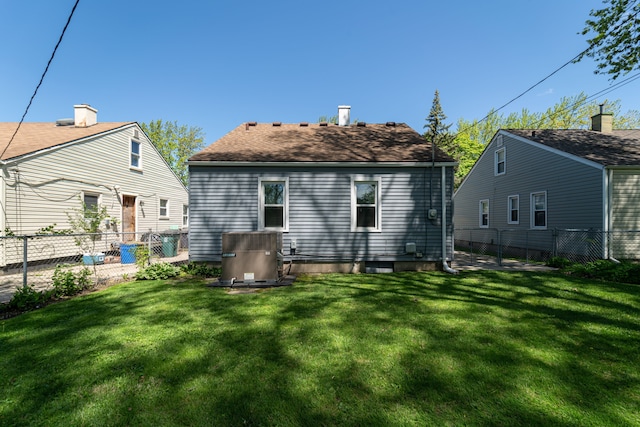 back of house with central AC