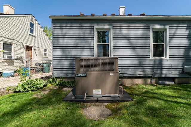 exterior view of central AC unit and fence