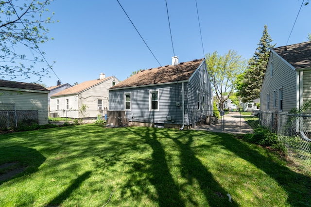 back of house featuring a chimney