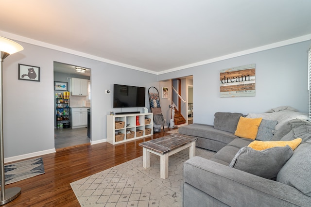 living area with wood finished floors, stairs, and baseboards