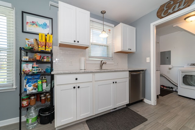 kitchen with stainless steel dishwasher, a sink, washer / dryer, decorative backsplash, and white cabinets