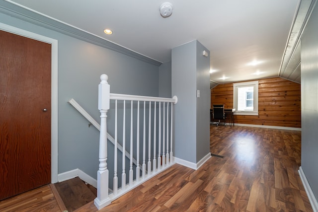 additional living space featuring wood finished floors, baseboards, vaulted ceiling, and wood walls
