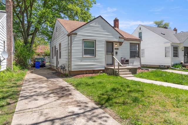 19720 Asbury Park, Detroit, MI 48235 - bungalow with driveway, a front yard, a chimney, and a shingled roof