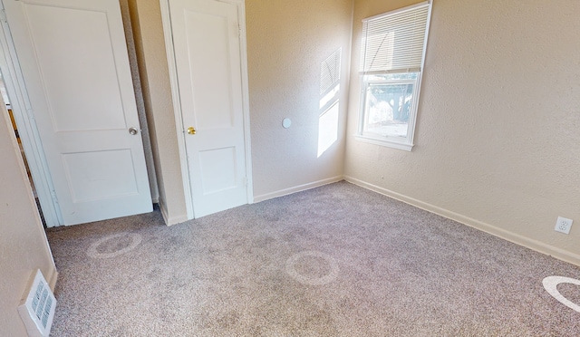 19720 Asbury Park, Detroit, MI 48235 - unfurnished bedroom with carpet, a textured wall, and baseboards