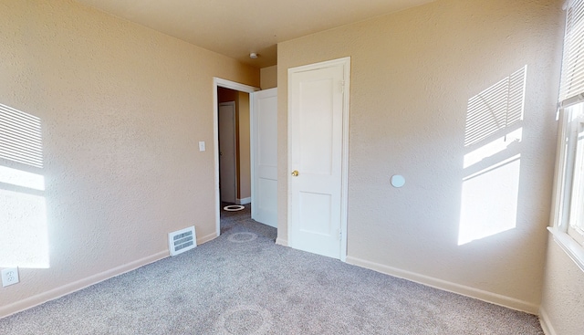19720 Asbury Park, Detroit, MI 48235 - unfurnished bedroom featuring carpet floors, a textured wall, and baseboards
