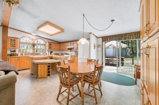 19251 Indian Dr, Paris, MI 49338 - dining space with a textured ceiling, lofted ceiling, and crown molding