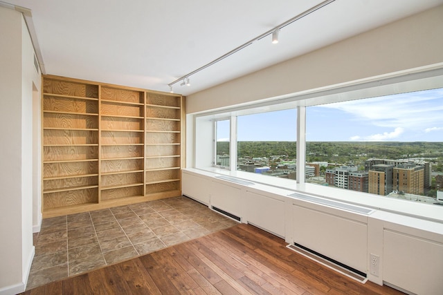 555 E William St Unit 25I, Ann Arbor, MI 48104 - unfurnished room with track lighting and hardwood / wood-style floors