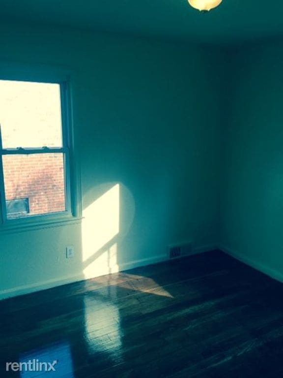 20244 Fairport St, Detroit, MI 48205 - spare room with baseboards and wood finished floors