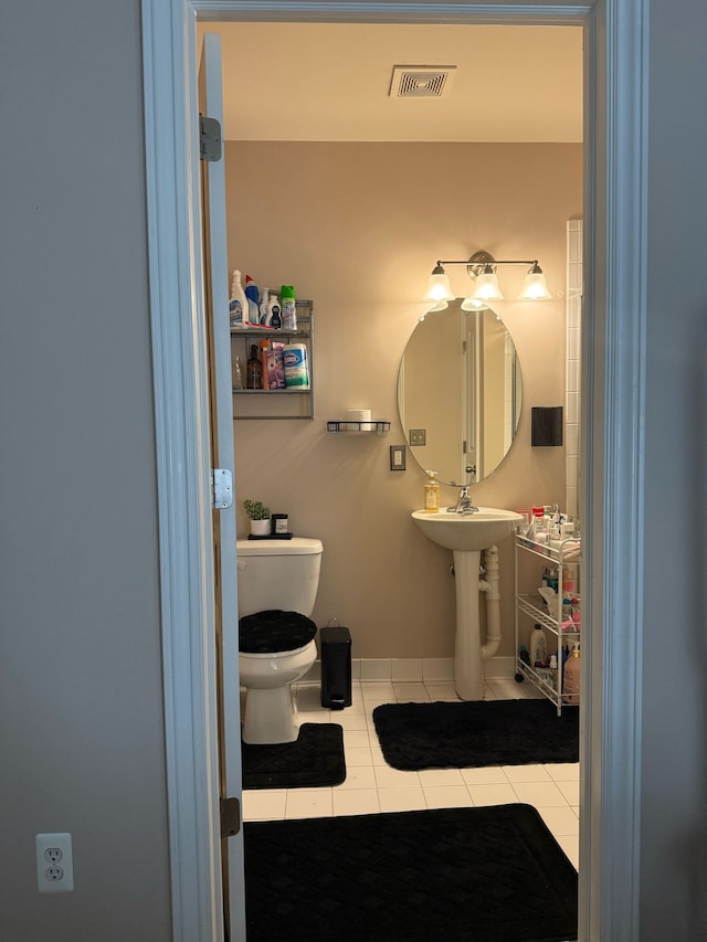 11702 Weingartz E, Utica, MI 48315 - half bath featuring tile patterned floors, toilet, and baseboards