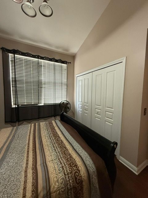 11702 Weingartz E, Utica, MI 48315 - bedroom featuring lofted ceiling, baseboards, and a closet