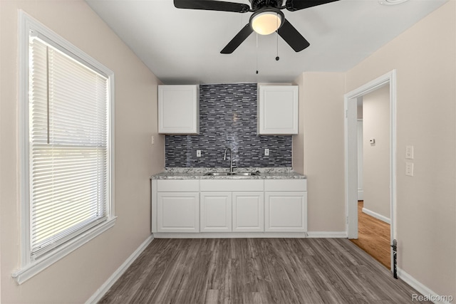 19327 Sunset St, Detroit, MI 48234 - kitchen with a sink, dark wood-style floors, tasteful backsplash, and white cabinetry