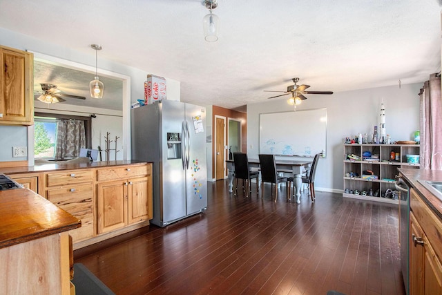 kitchen featuring appliances with stainless steel finishes, a ceiling fan, dark wood-type flooring, and baseboards