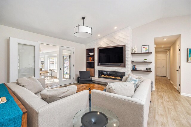 55 Gabriel Dr, South Haven, MI 49090 - living room with lofted ceiling, light wood-style flooring, a fireplace, baseboards, and recessed lighting