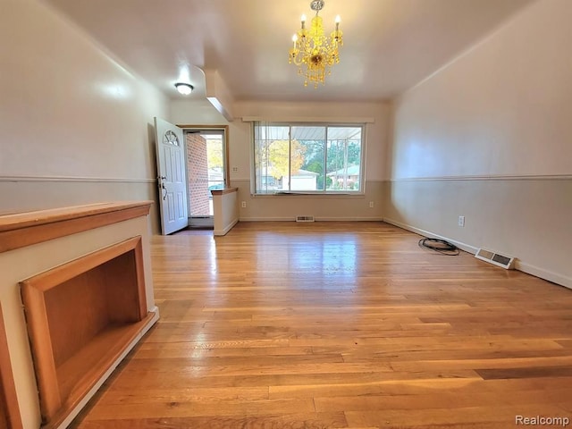 28142 Liberty Dr, Warren, MI 48092 - unfurnished dining area featuring a chandelier, light wood-style floors, and baseboards